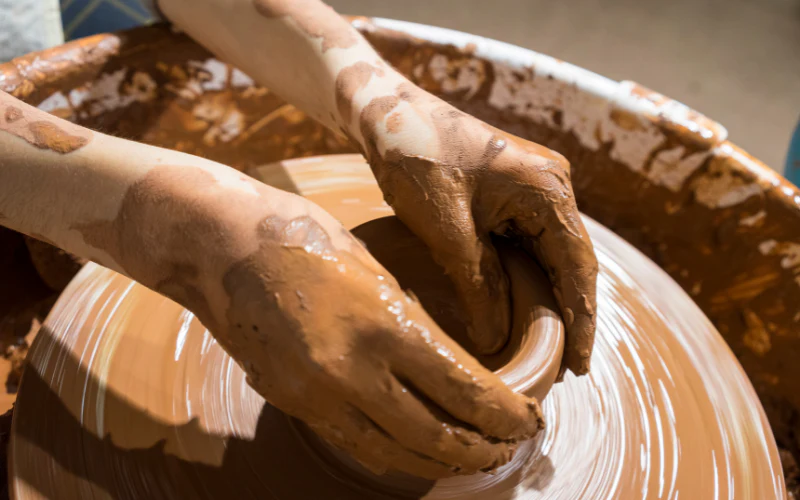 Hands shaping clay